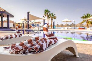 Indoor pool, outdoor pool, open 9 AM to 7 PM, pool umbrellas