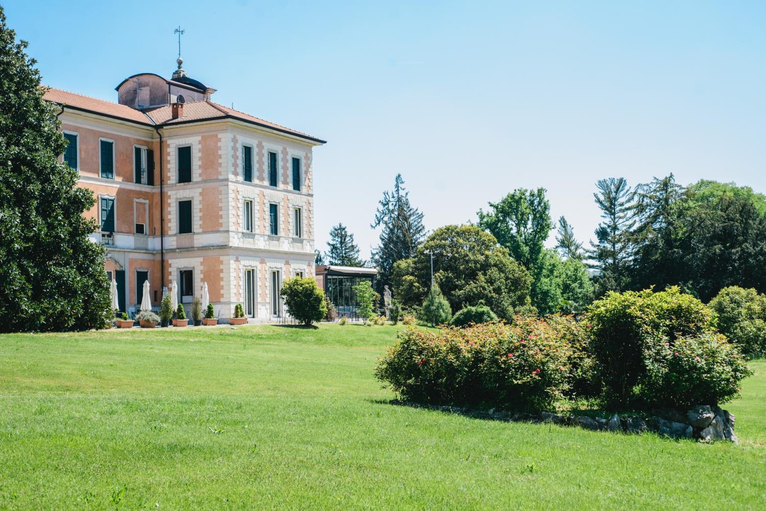 A large, multi-story building with a symmetrical facade, a central entrance, and a well-maintained lawn.