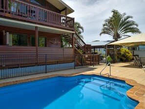 Enjoy a tranquil view from the upper-level balcony overlooking the pool area.