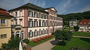 A large, multi-story building with a symmetrical facade, arched windows, and a central entrance. - Badhotel Bad Brückenau (Bad Brueckenau)