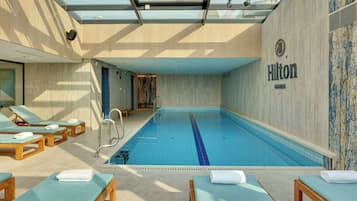 Indoor pool, open 9:30 AM to 9:00 PM, pool loungers