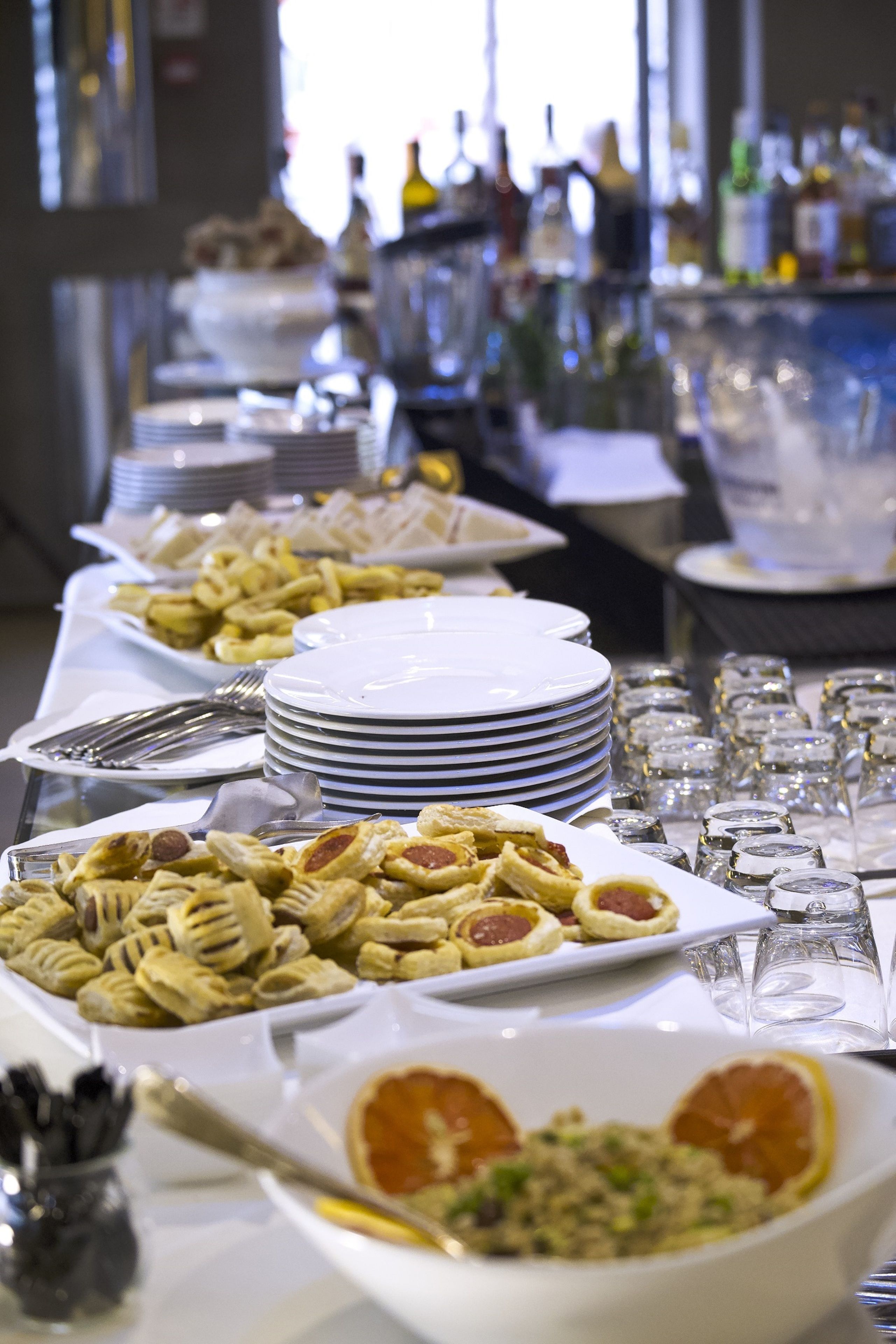 Ein reichhaltiges Buffet mit verschiedenen Speisen, Tellern und Gläsern.