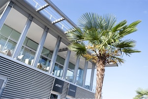 A modern building with a lounge bar and a sign indicating a jetset.