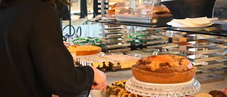 A buffet with various desserts and pastries.