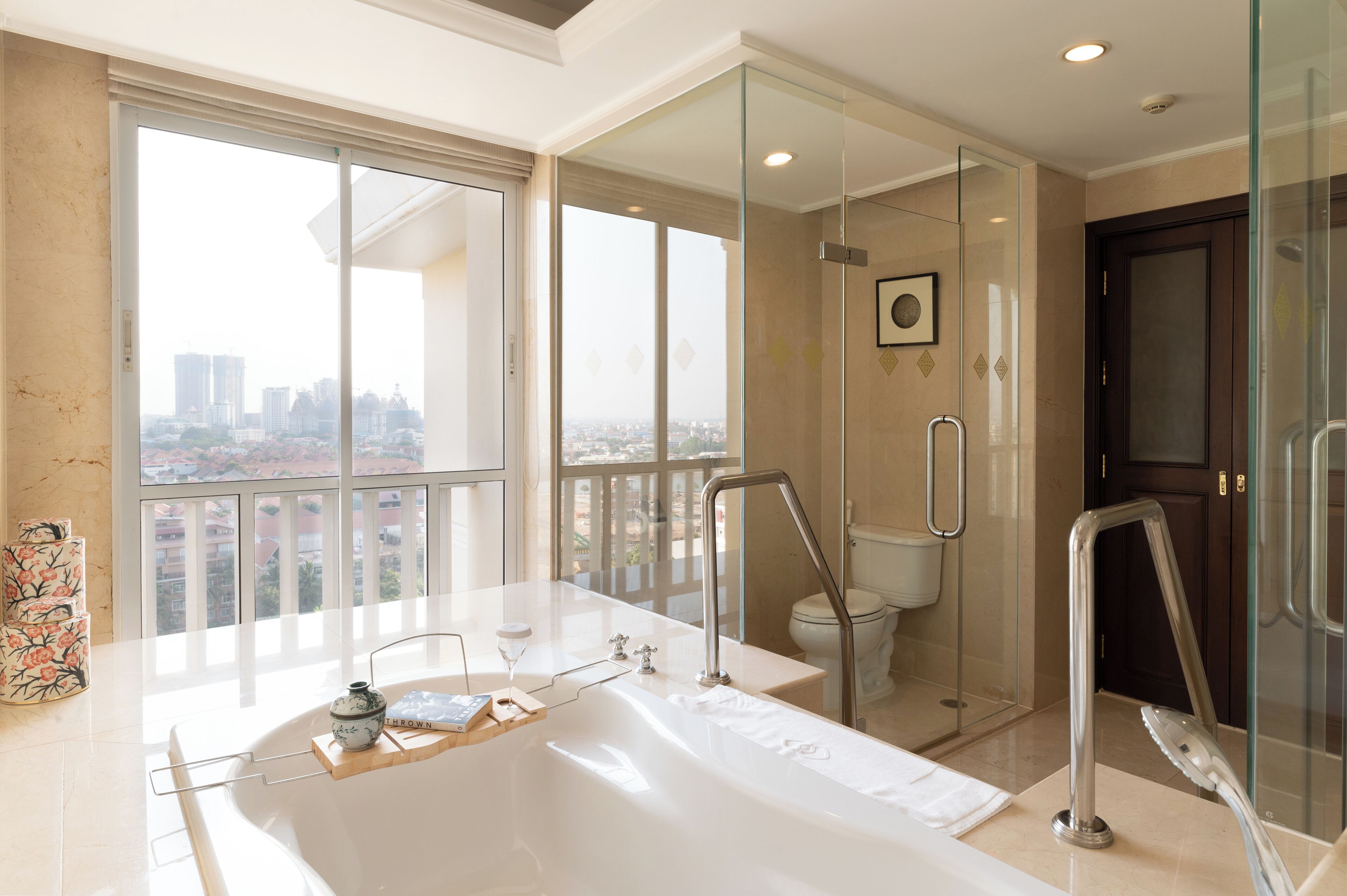 A modern bathroom with a large bathtub, a glass-enclosed shower, and a toilet.