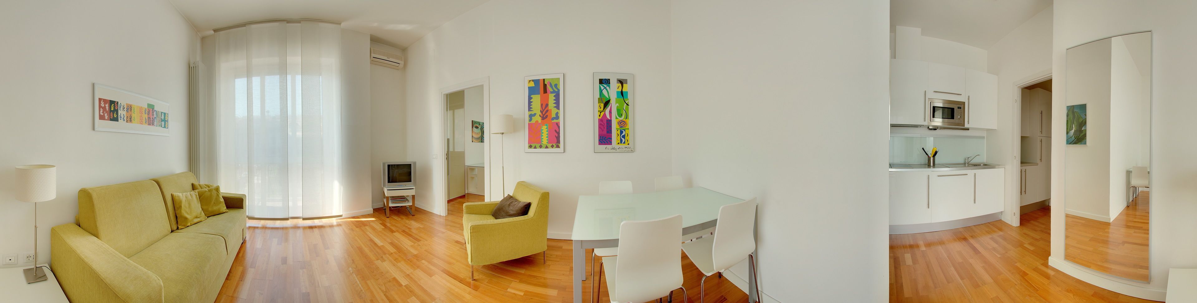 Un apartamento moderno con sala de estar, comedor y cocina.