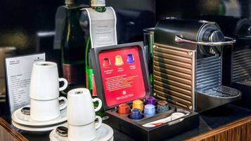 A coffee station with a coffee machine, cups, and a menu.