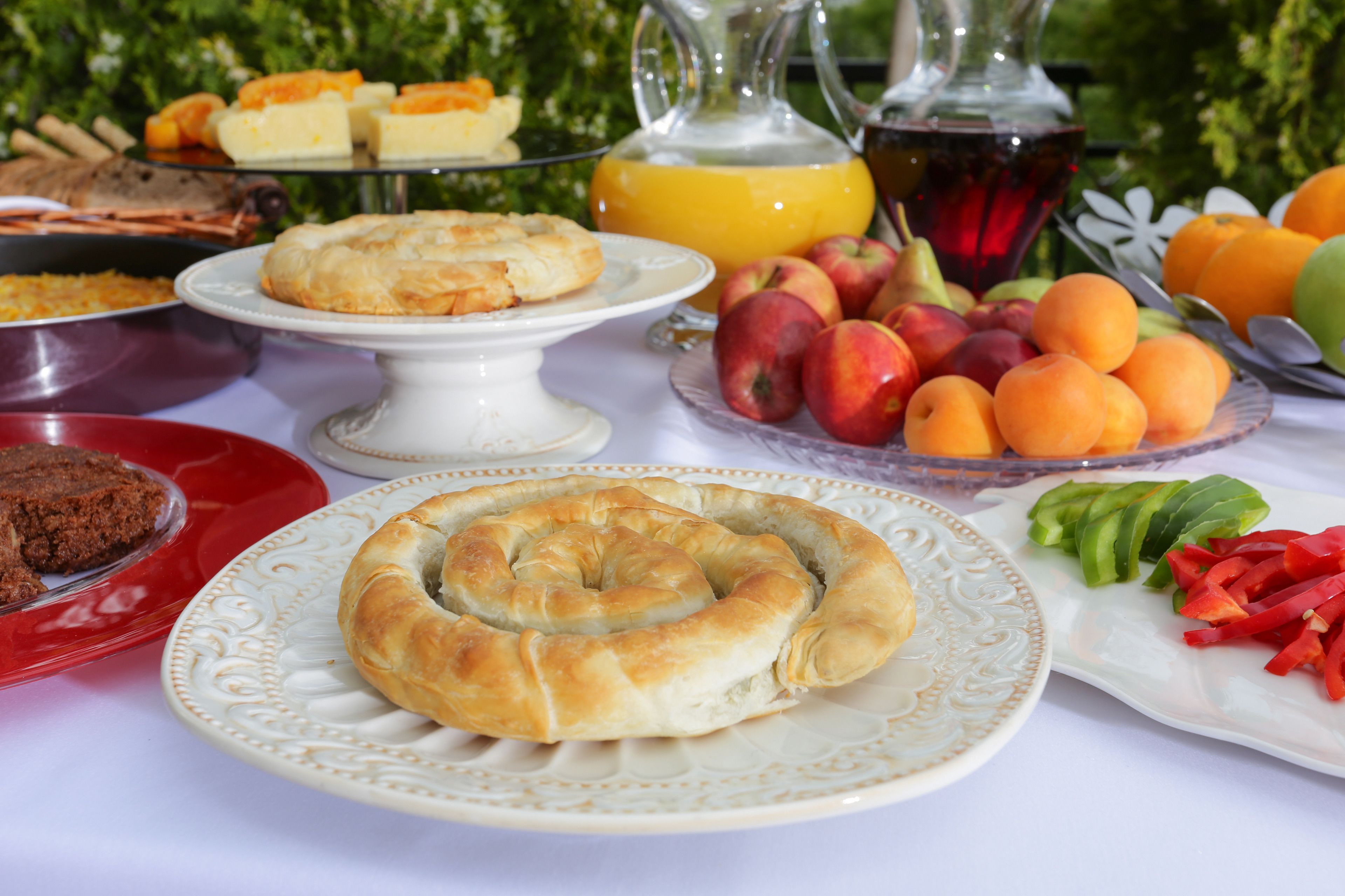 A table with various food items including pastries, fruits, and beverages.