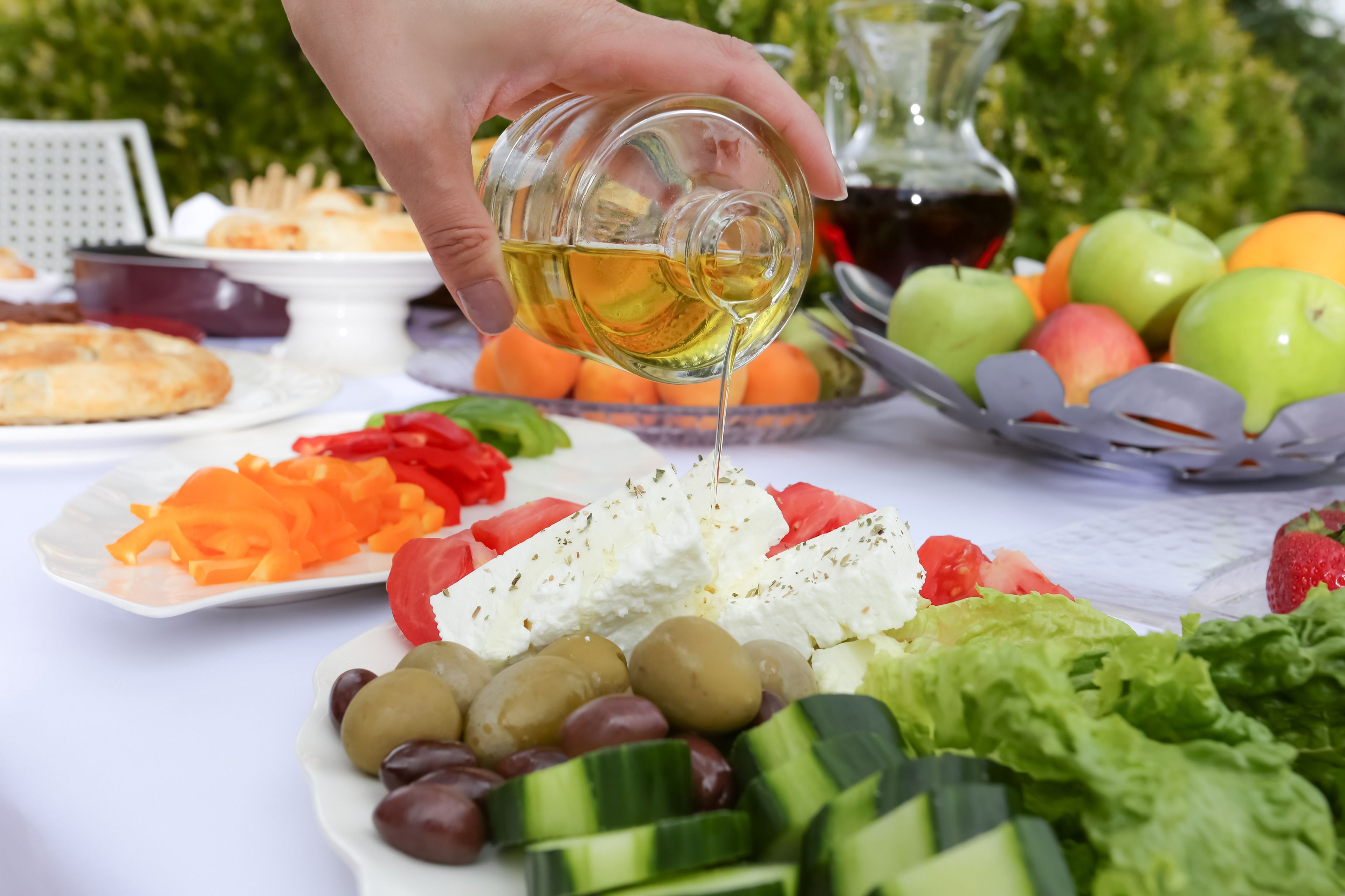 A table with various foods including olives, cheese, and vegetables.