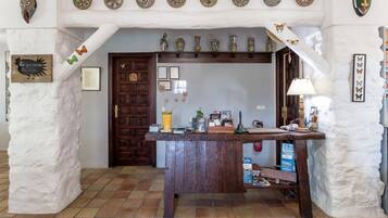 A rustic interior with a wooden counter, a door, and various decorative items.