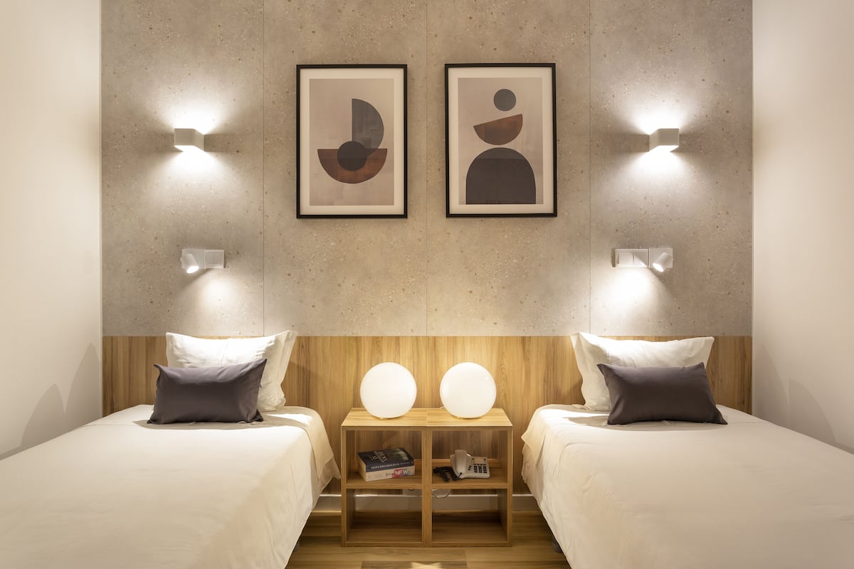 standard twin room | in-room safe, individually decorated, desk, blackout curtains