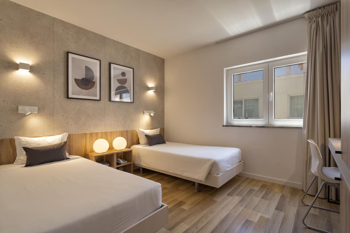 standard twin room | in-room safe, individually decorated, desk, blackout curtains