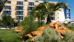Un hotel con varios pisos, balcones y zonas de estar al aire libre.