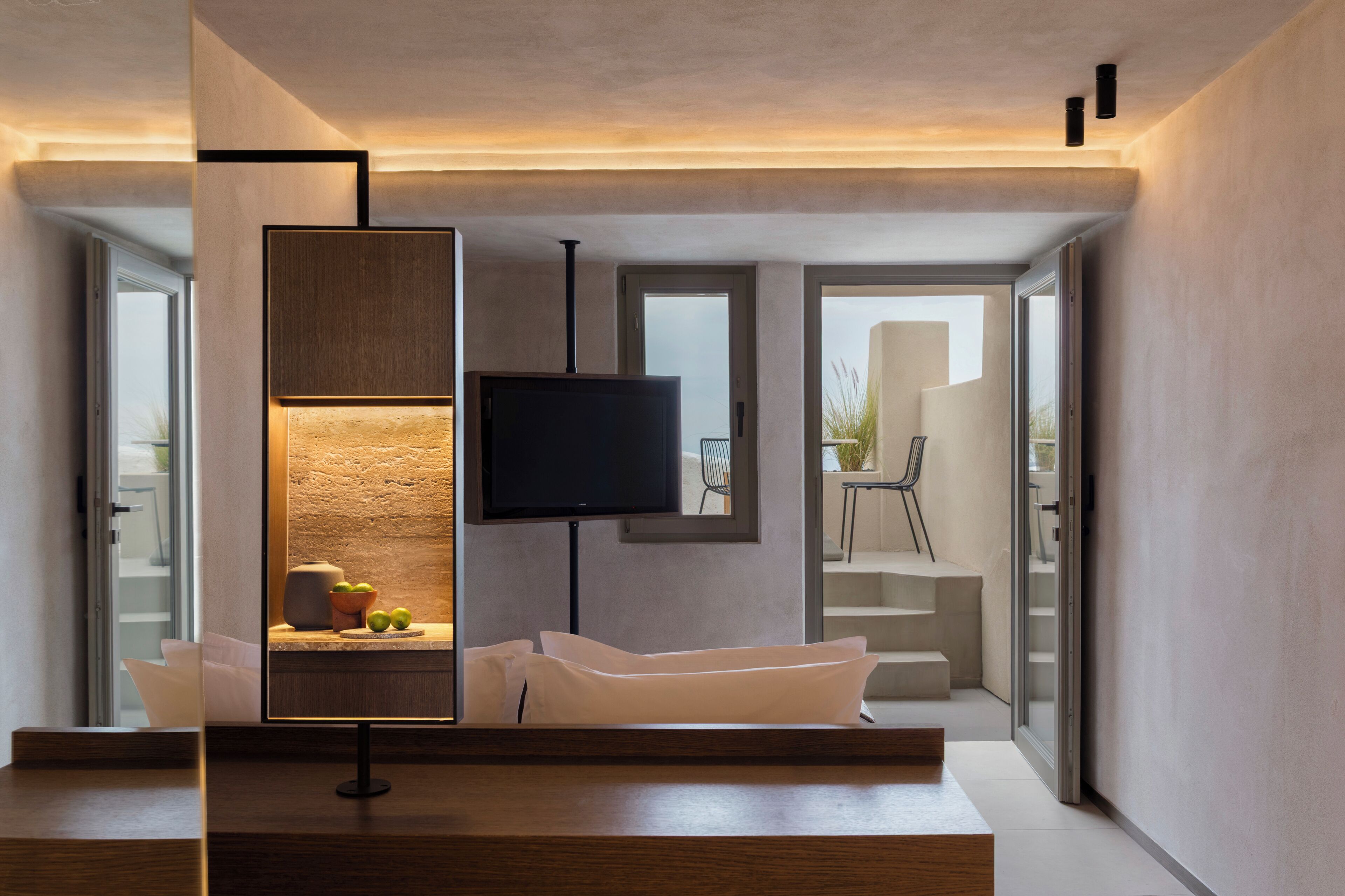 A modern living room with a flat-screen TV, a sofa, and a coffee table.