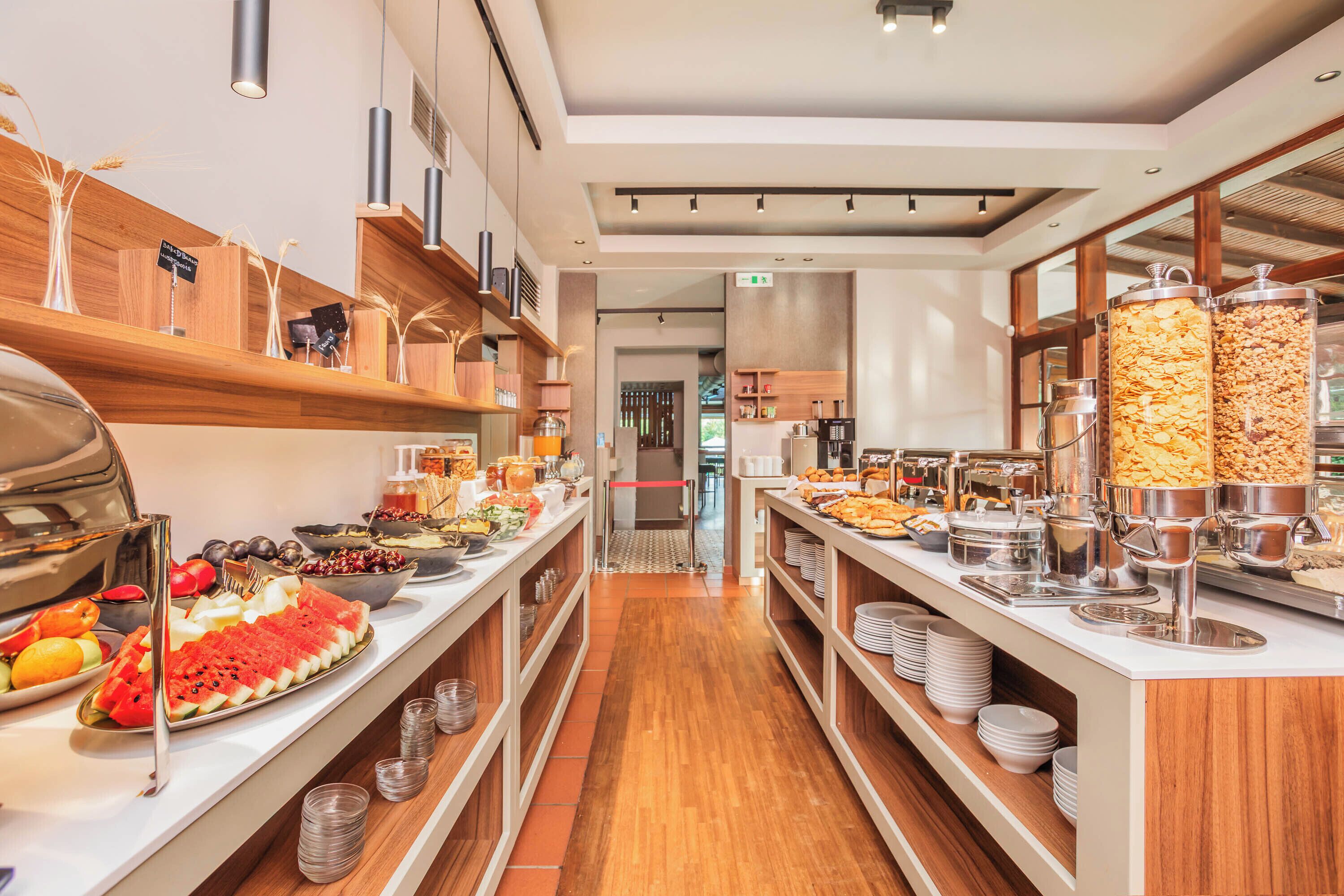 A buffet setup with various food items and serving utensils.