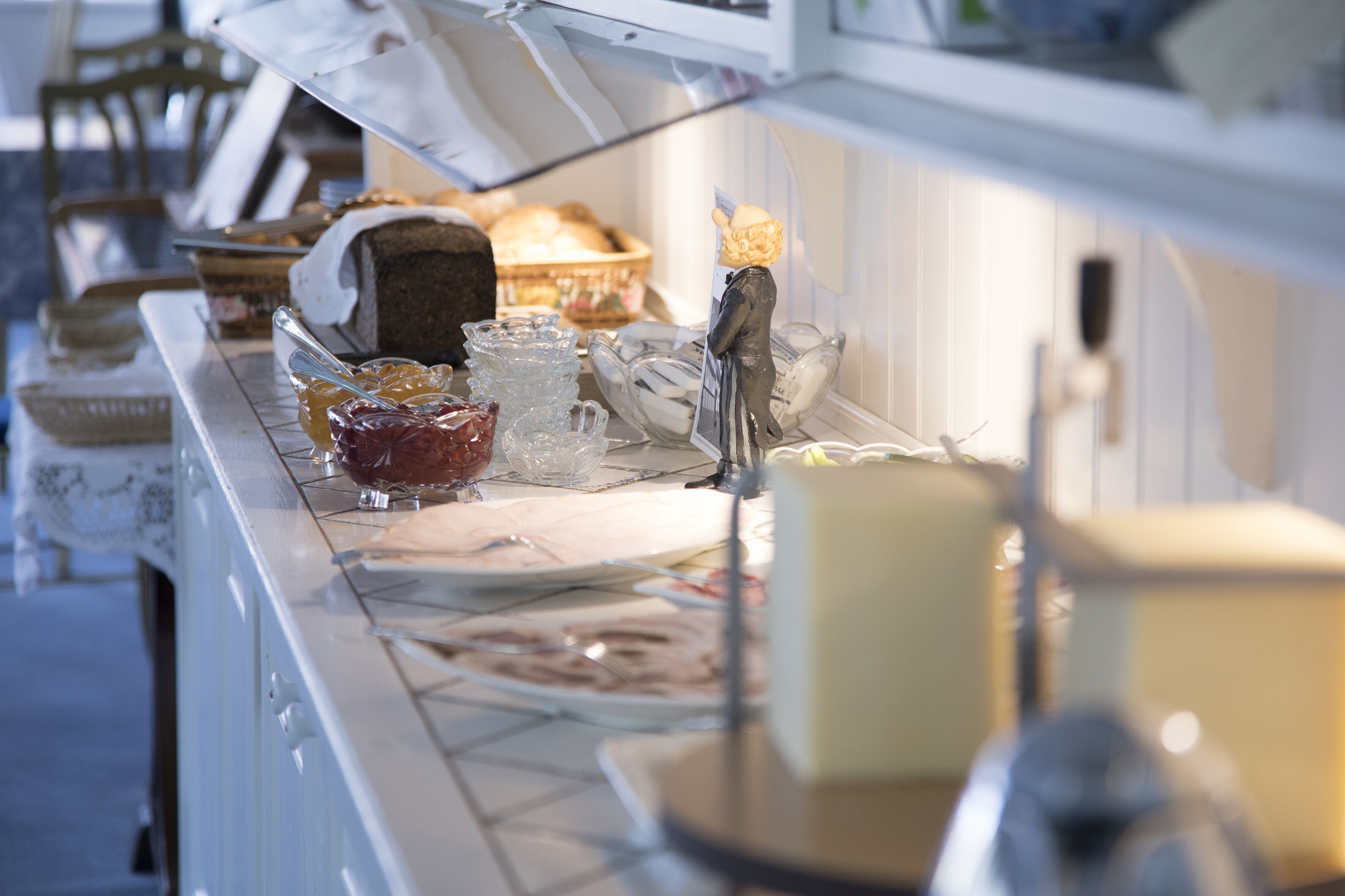 A buffet setup with various food items and utensils.