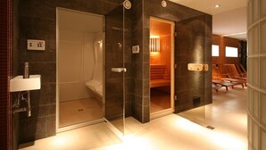 A modern bathroom with a glass-enclosed shower, a built-in bench, and a heated floor. - Apartments Sopot (Sopot)