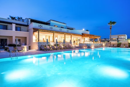 Outdoor pool, pool umbrellas, pool loungers. Aegean Houses