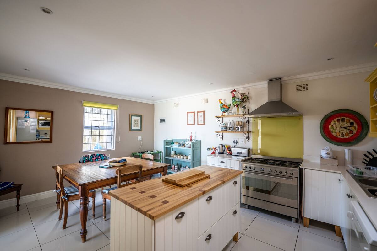 A kitchen with a central island, a stove, and a sink.