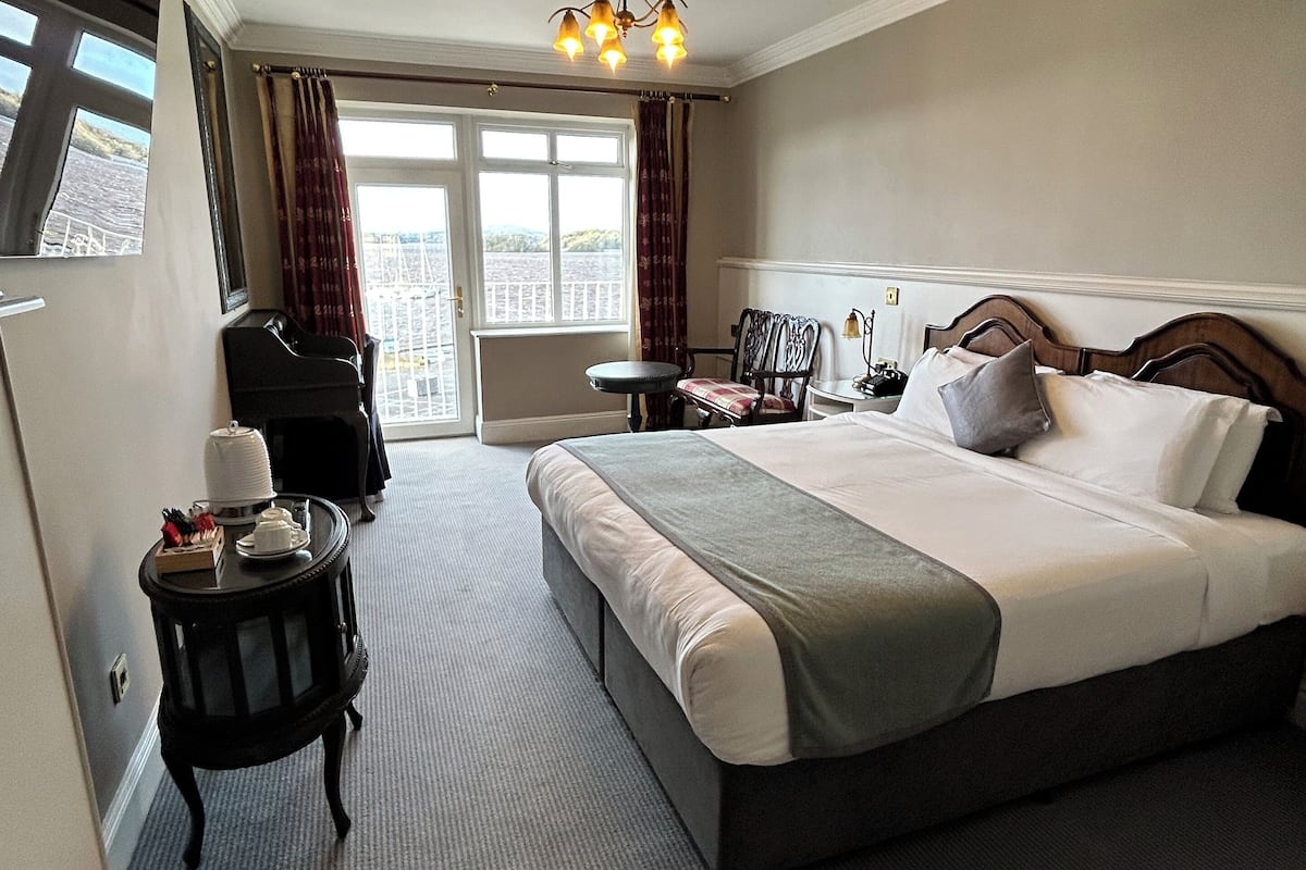 superior double room, lake view | in-room safe, desk, laptop workspace, iron/ironing board