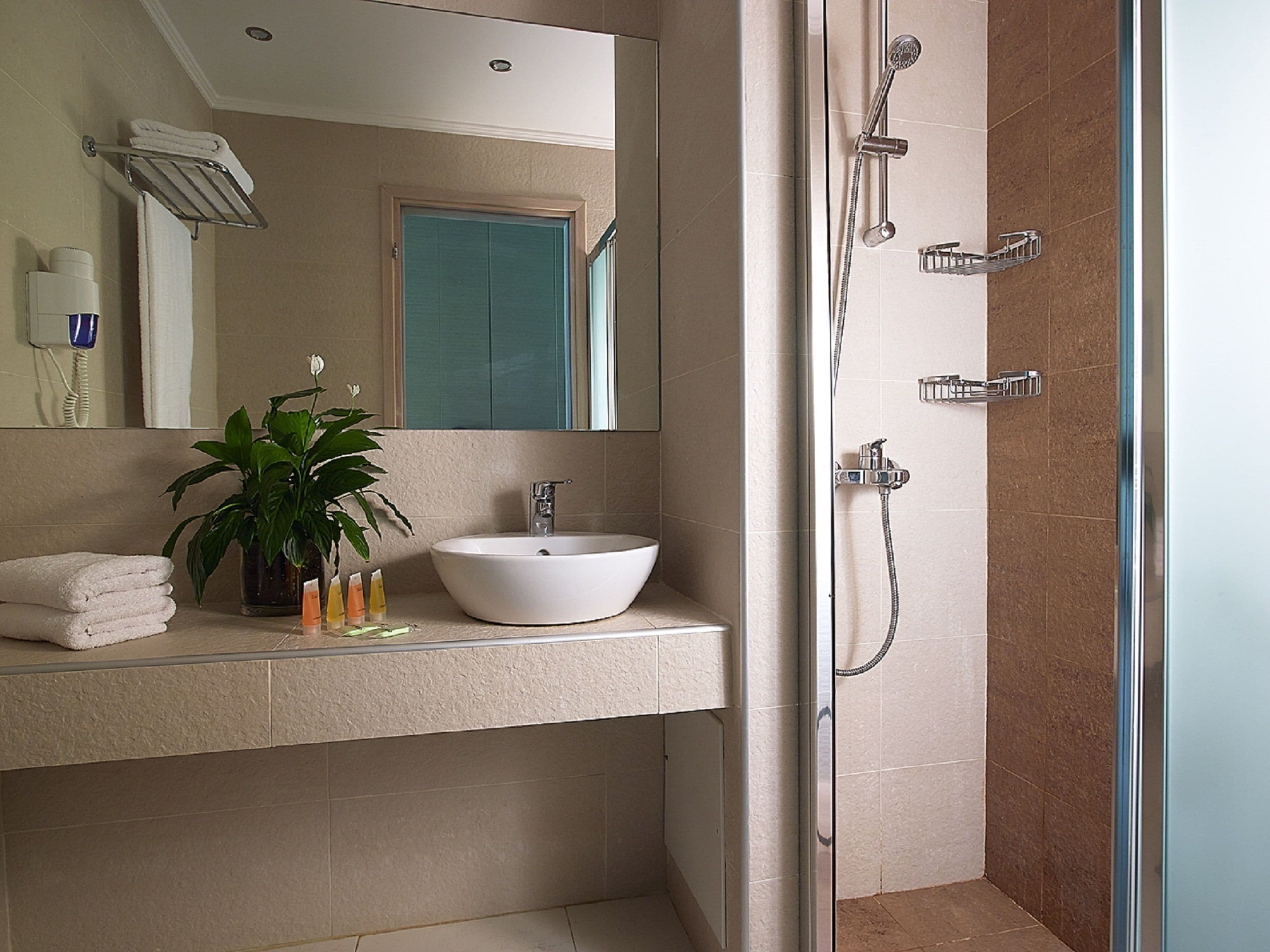 superior room, garden view | bathroom | shower, hair dryer, towels, soap