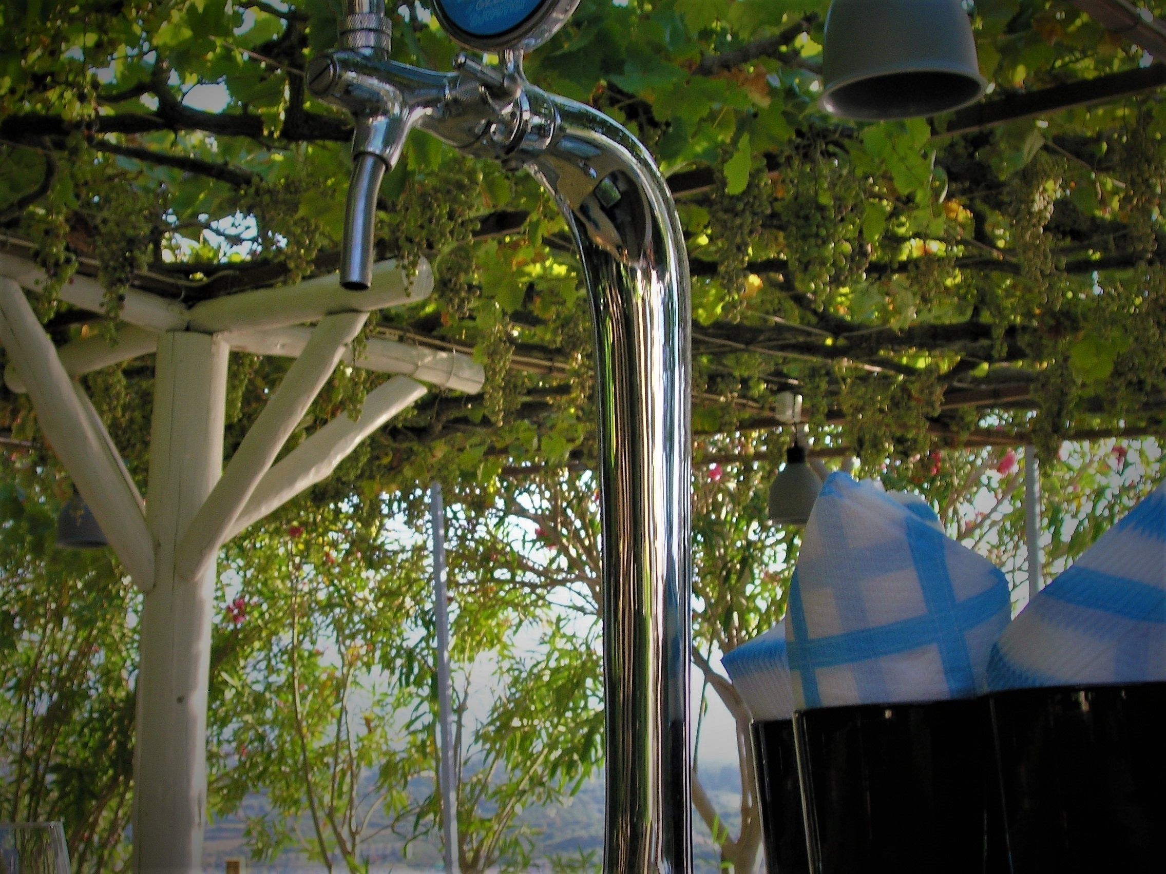 A metal structure with a faucet and a water spout.