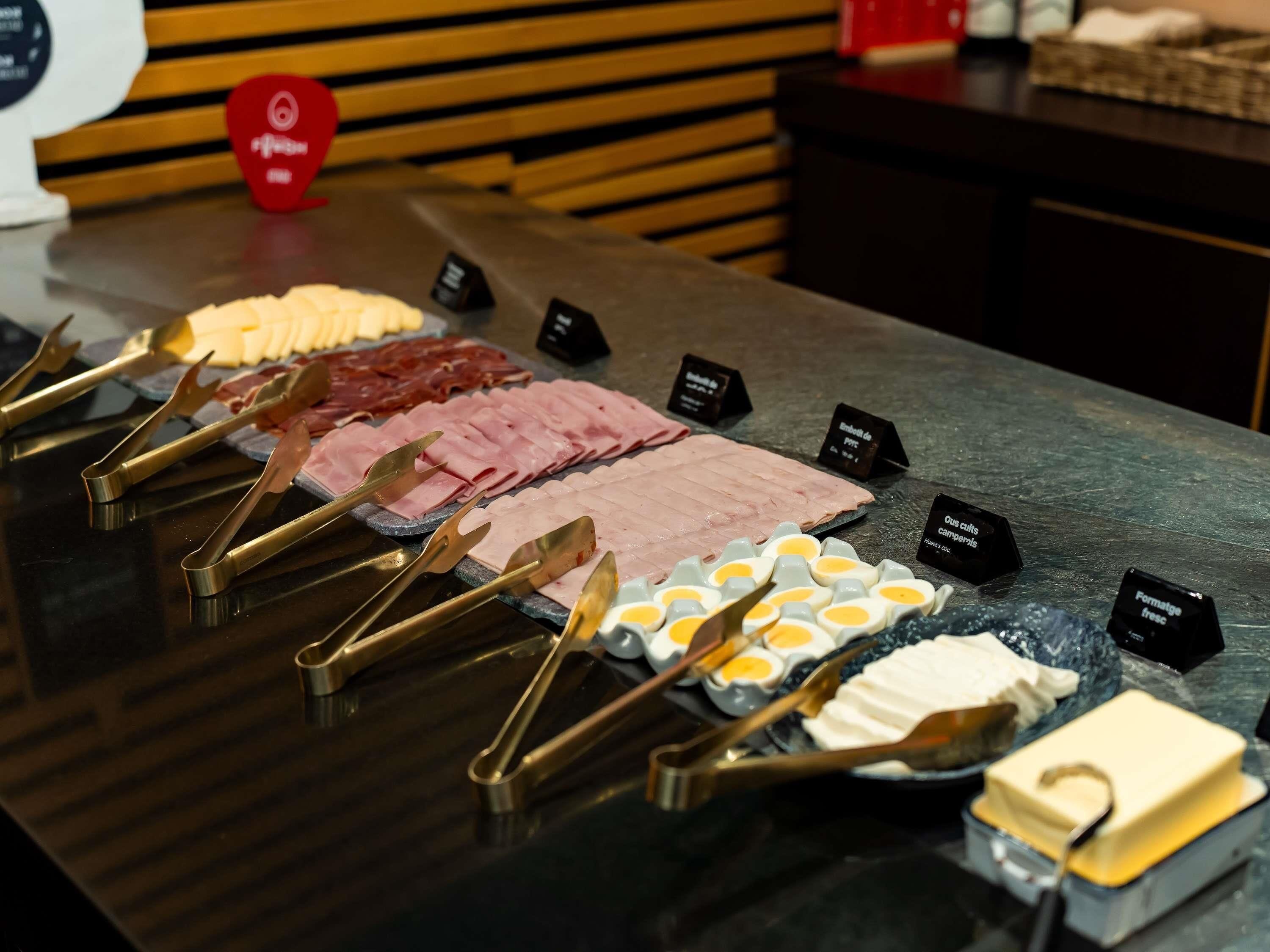 A buffet with various meats and eggs.