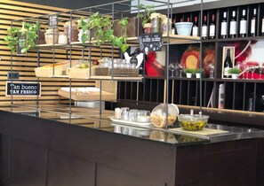 A buffet area with various food items and condiments. - ibis Barcelona Ripollet (Ripollet)