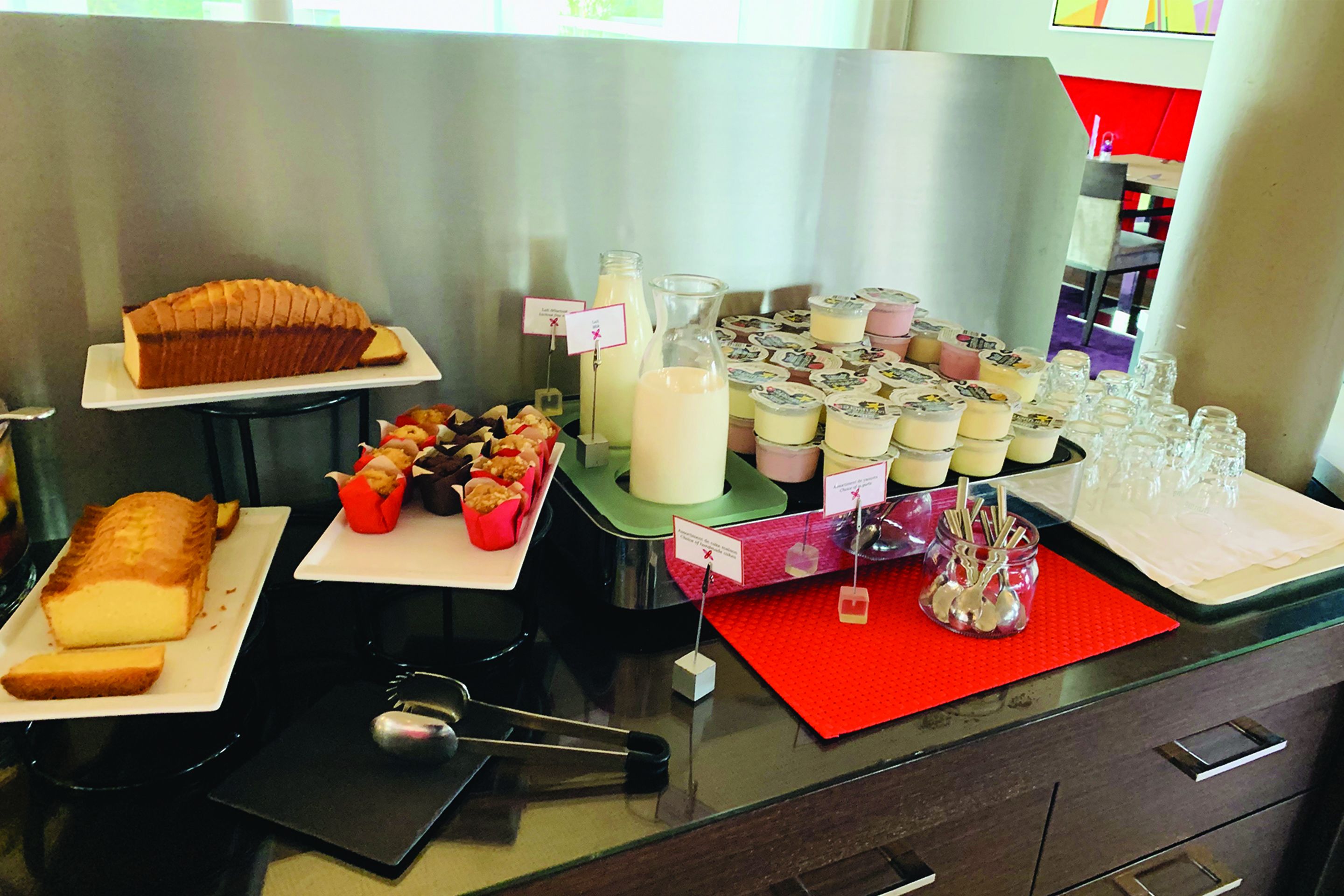 A buffet table with various food items and beverages.
