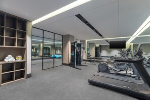 A modern gym with a treadmill, weight machines, and exercise balls. - voco Suzhou Guanqian Street by IHG (Suzhou)