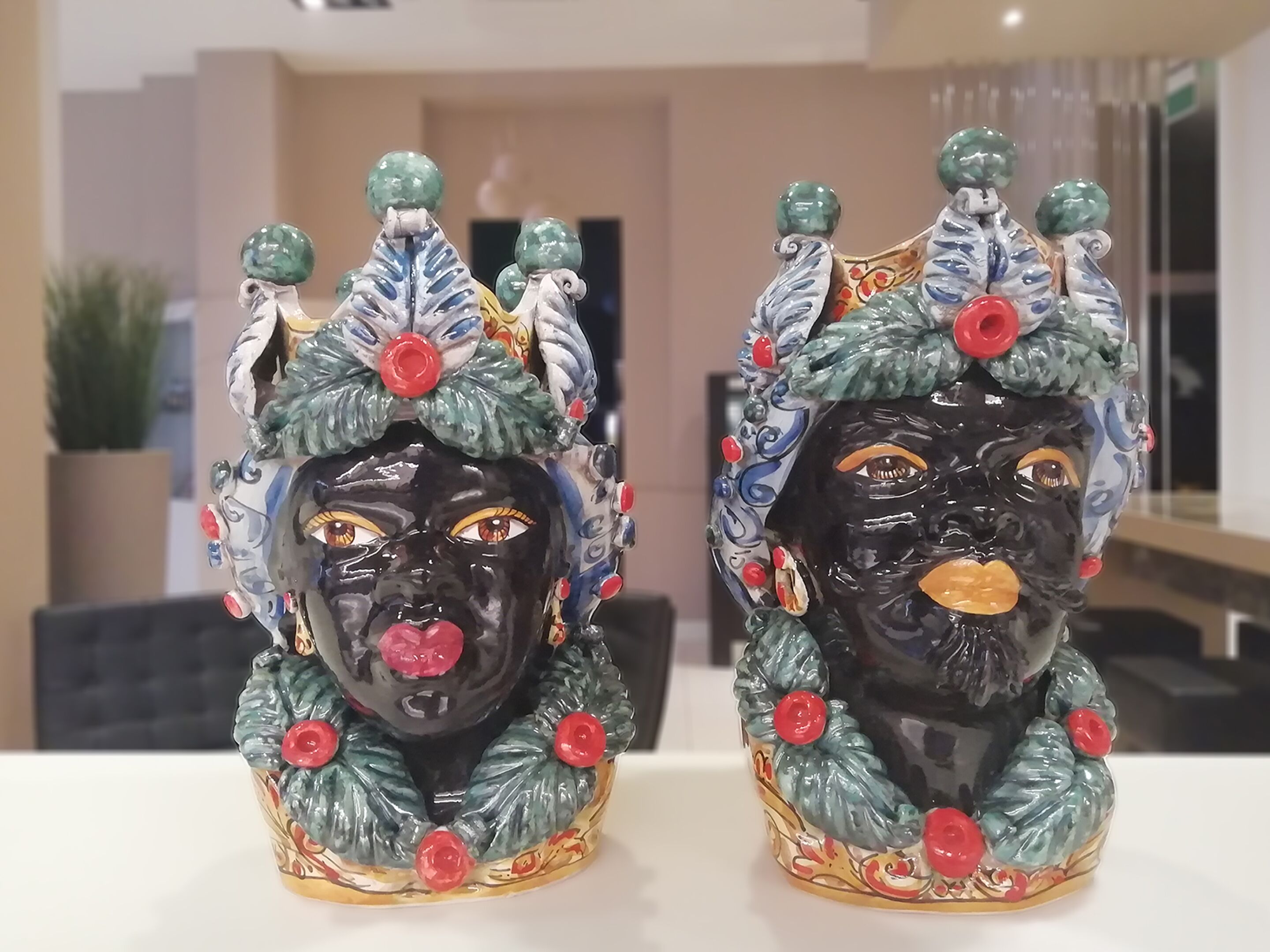 Two ceramic figurines with intricate designs and colorful decorations.