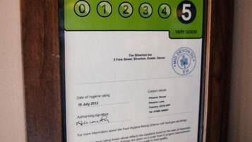 A framed food hygiene rating certificate with a rating of 5 (very good).