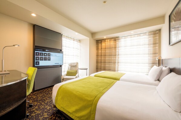 A hotel room with two beds, a desk, a chair, a TV, and a window with blinds. - remm Hibiya (Tokyo)