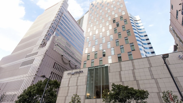 A modern building with a glass facade and a prominent 'SMR' sign.