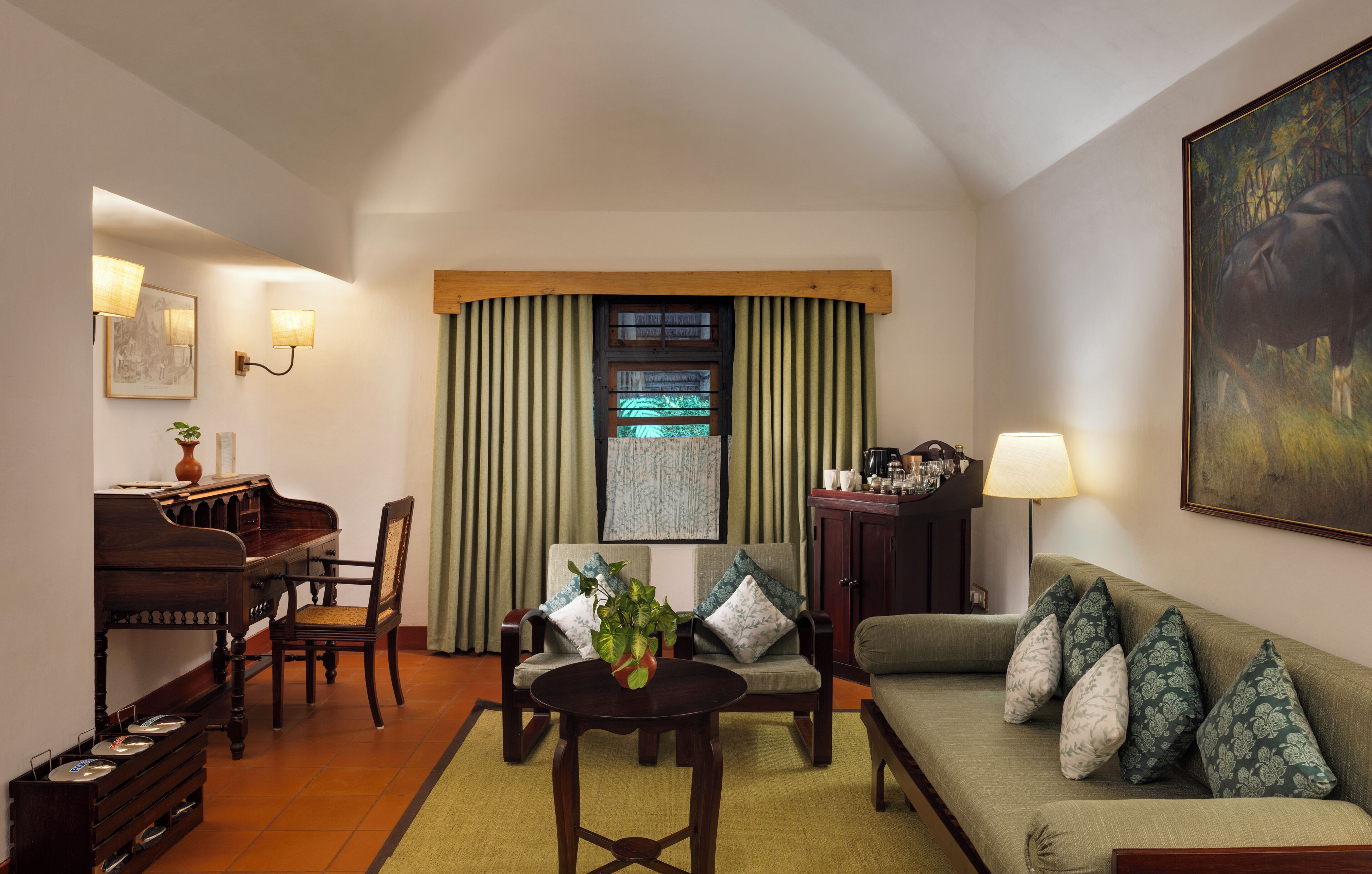 A cozy living room with a piano, a sofa, a coffee table, and a painting on the wall.