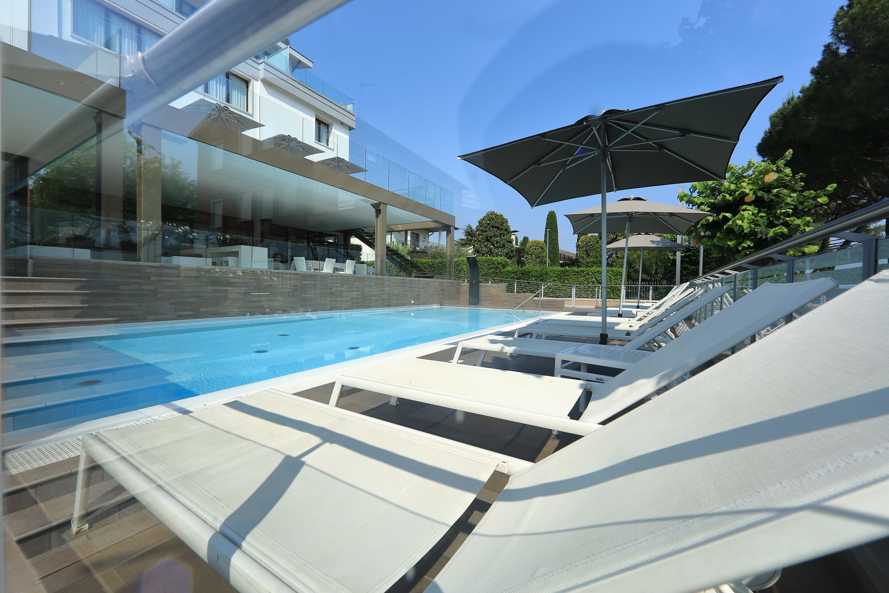Seasonal outdoor pool, pool umbrellas, pool loungers