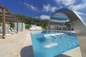 Seasonal outdoor pool, open 10:00 AM to 6:30 PM, pool loungers