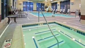 An indoor swimming pool with multiple lanes, lounge chairs, and a no diving sign. - Hampton Inn & Suites Spokane Valley (Spokane Valley)