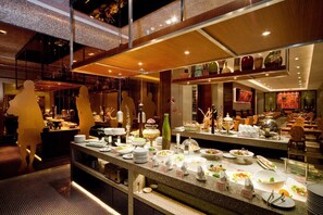 A buffet setup with various dishes and a decorative backdrop. - Guangzhou Carat Hotel (Guangzhou)
