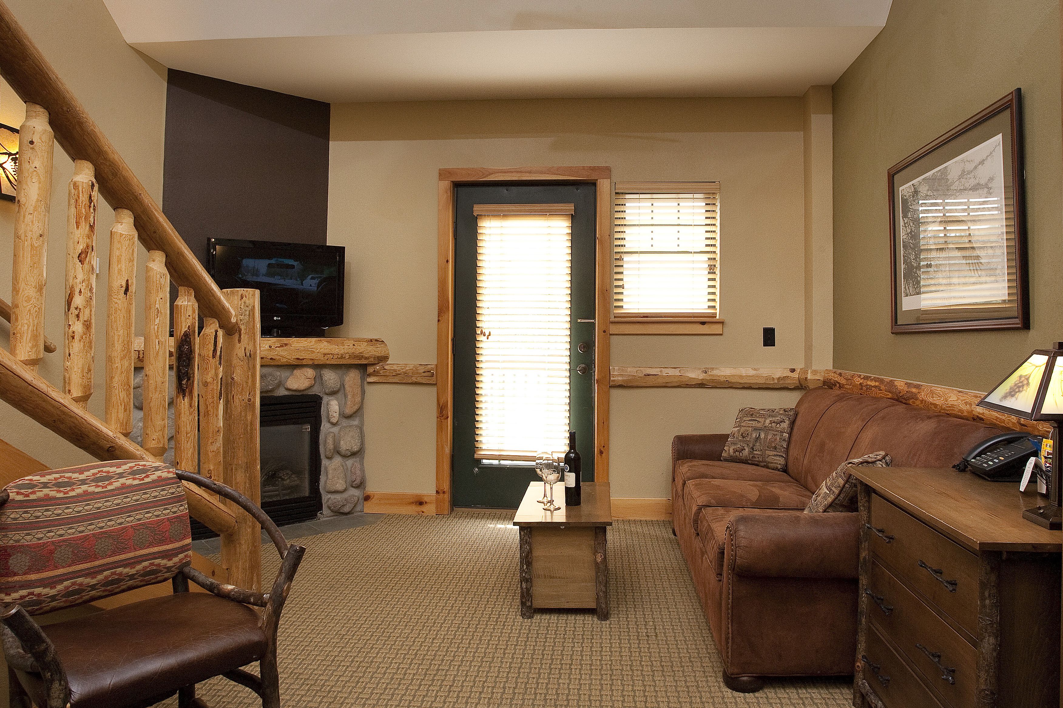 roaring brook suite - waterpark access additional | living area | 32-inch flat-screen tv with cable channels, tv, fireplace