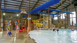 An indoor water park with multiple water slides and pools.