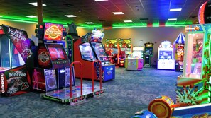 An arcade with various gaming machines, including Yahtzee and Dance Revolution. - Hope Lake Lodge & Indoor Waterpark (Cortland)