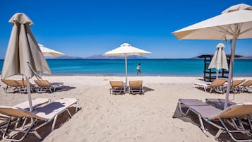 On the beach, sun loungers, beach umbrellas, beach towels