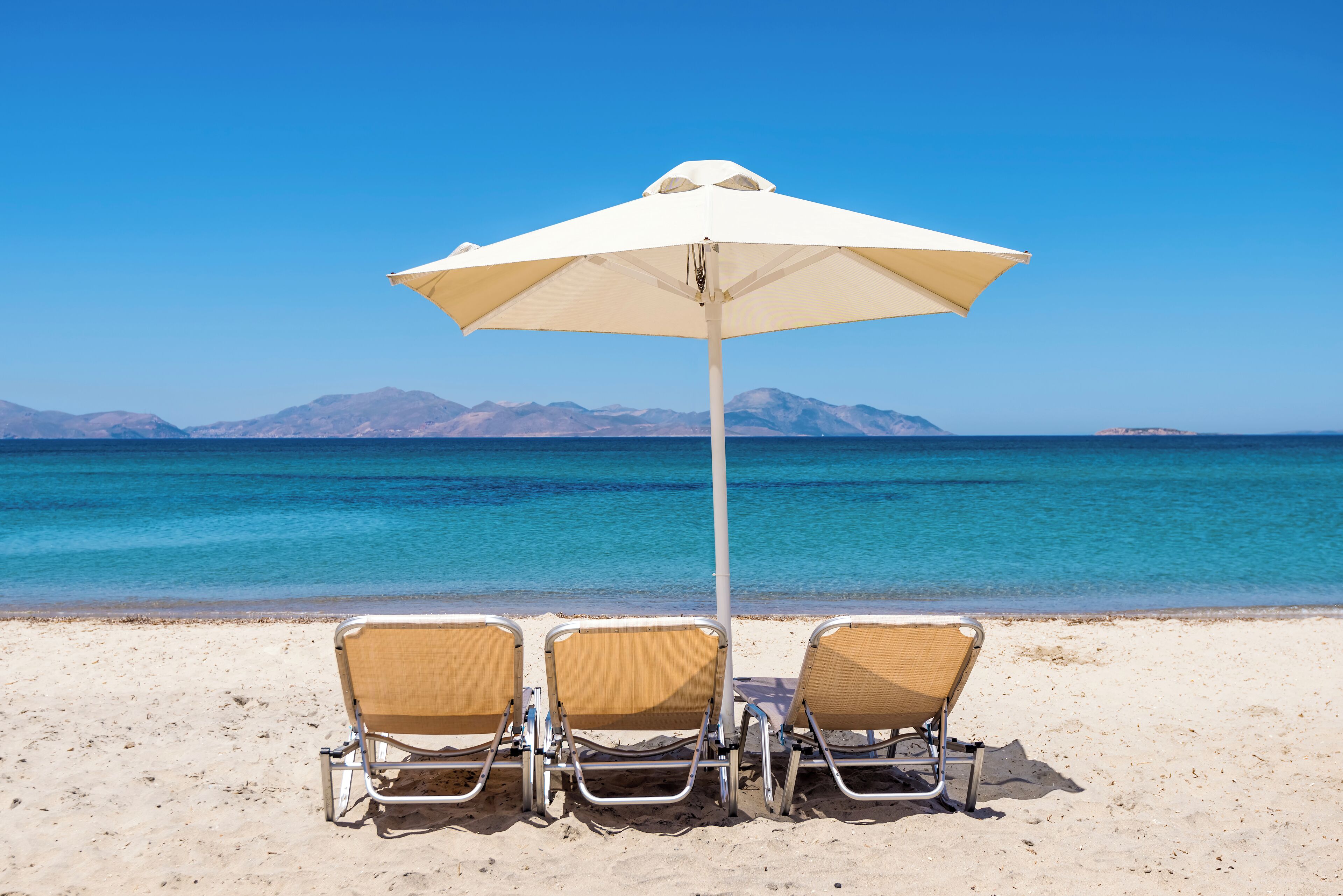 On the beach, sun loungers, beach umbrellas, beach towels