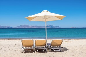 On the beach, sun-loungers, beach umbrellas, beach towels