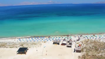 On the beach, sun-loungers, beach umbrellas, beach towels