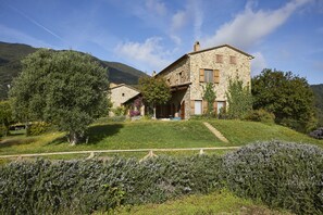 Situated on a grassy hill, this traditional building offers a serene mountain view.