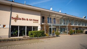 A hotel with a modern facade, large windows, and a covered entrance.
