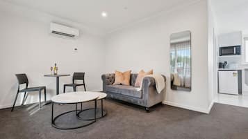 Luxury Room, 1 Bedroom | Living area | TV