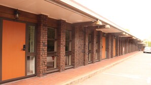 A building with a brick facade, large windows, and a covered walkway. - Beetham Park Motel (Hamilton)